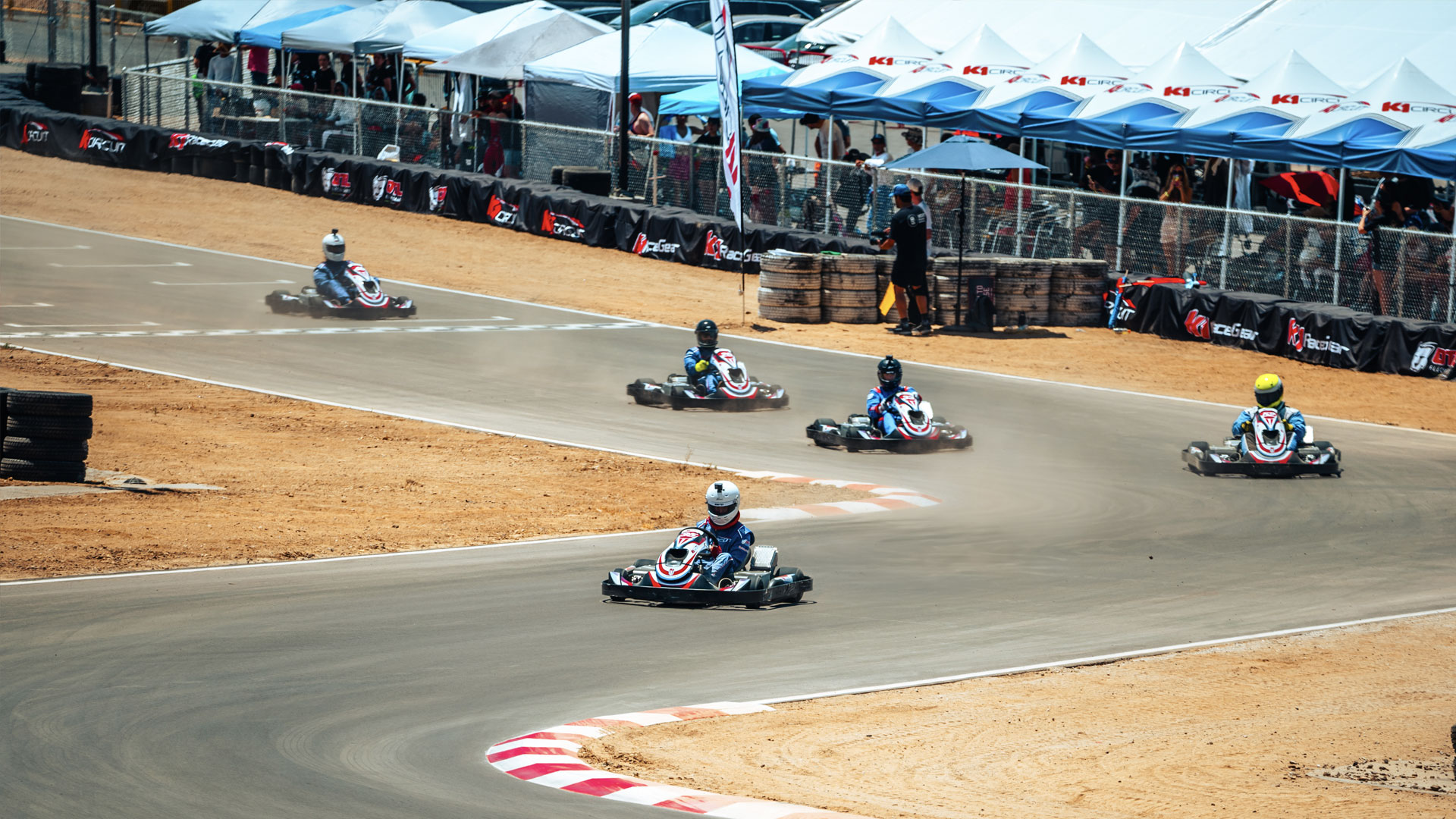 5 OTL E-Pro kart racers at turn 1.