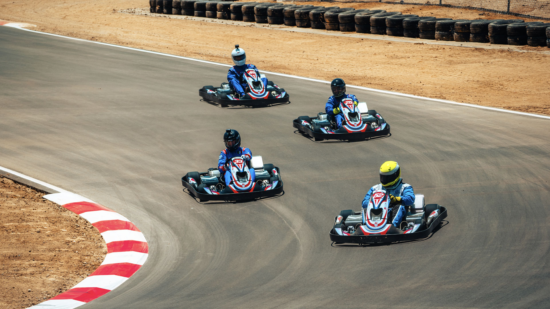 4 karts racing through a corner