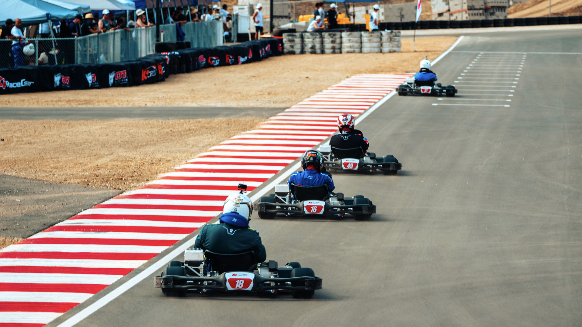 4 OTL E-Pro karts on the front straight.