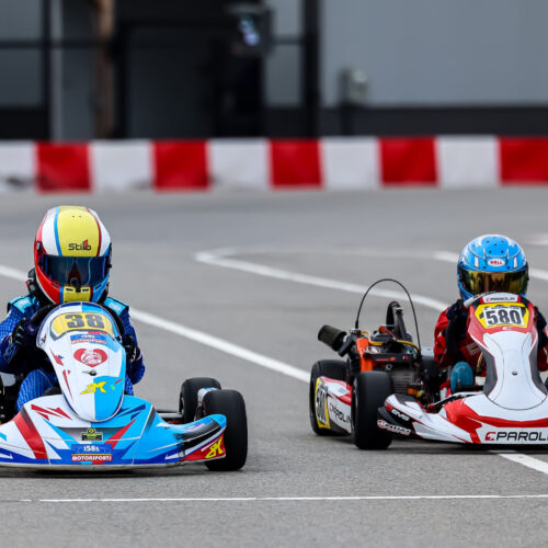 two go-kart race wheel-to-wheel at k1 circuit whiteland during an indy karting challenge event