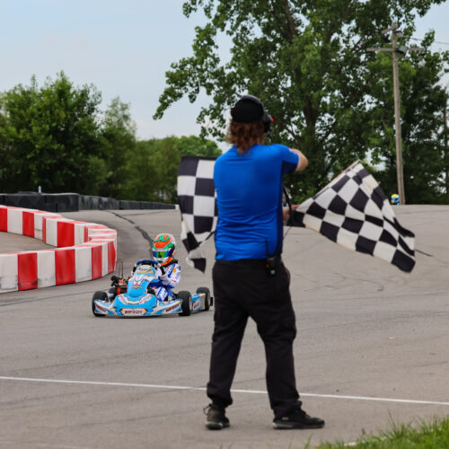 a k1 circuit employee waves double checkered flags at k1 circuit whiteland during the indy karting challenge race