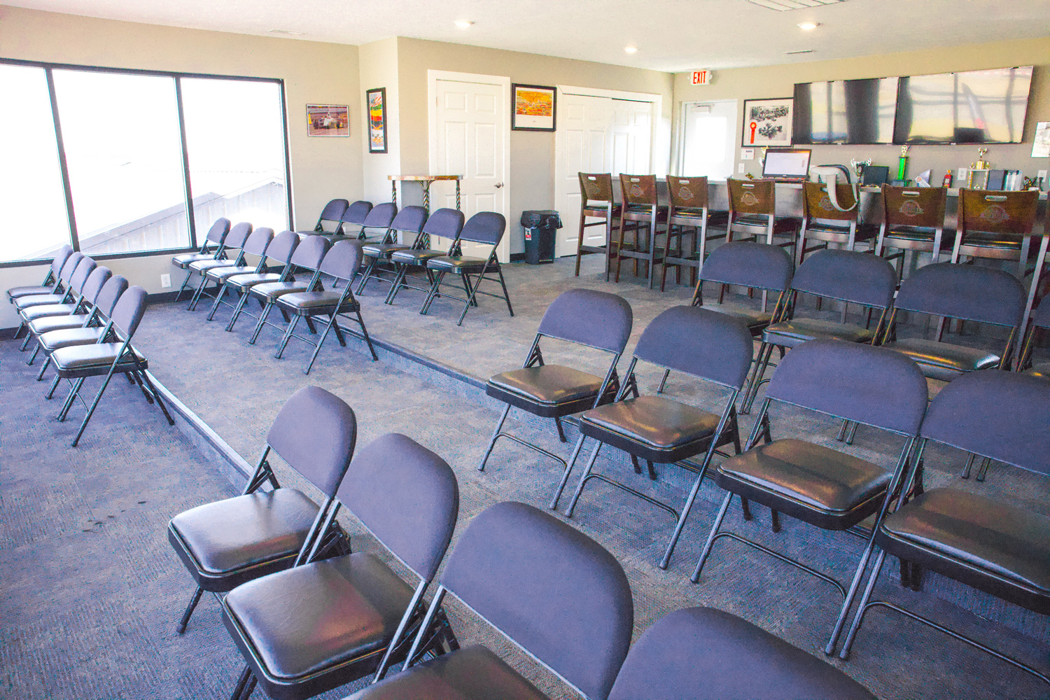 rows of chairs and a bar in the vip suite at k1 circuit whiteland