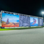 A large banner backdrop sits along the main straight at K1 Circuit Winchester