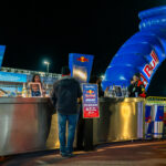 People approach a Red Bull counter at K1 Circuit in Winchester