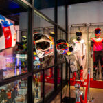 Helmets and suits on display in the lobby at K1 Circuit during a private event for Red Bull, Troy Lee Designs, and Ducati